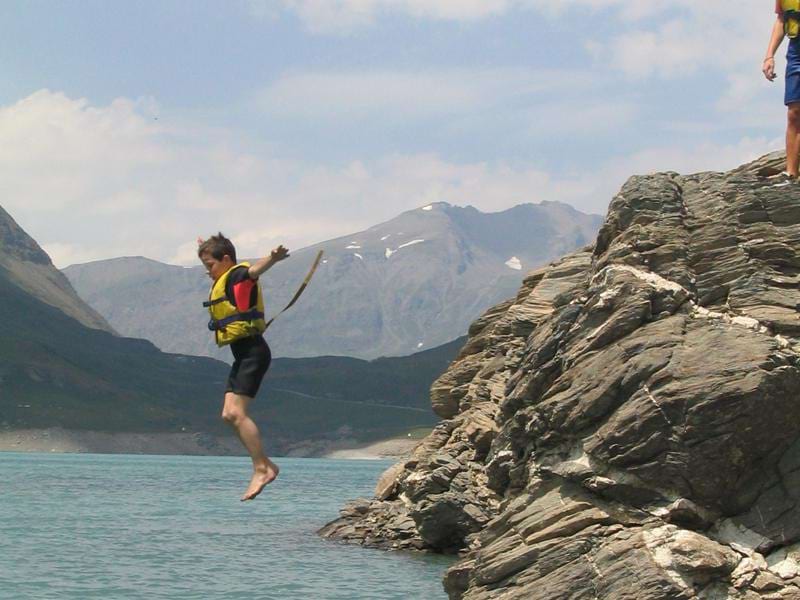 enfant sautant à l'eau en colonie de vacances multiactivités cet été