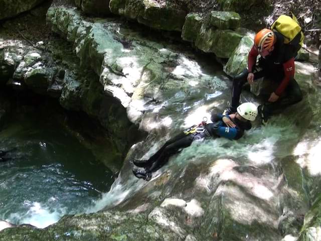 Enfant et son animateur de colonie de vacances faisant du canyoning en colonie de vacances multiactivités dans le verdon été