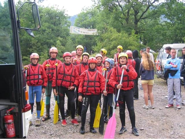 Groupe d'enfants en tenue de canoe kayak en colonie de vacances à la montagne cet ét