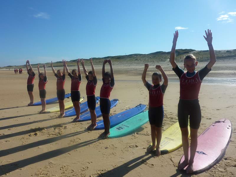 Enfants découvrant le surf en colonie de vacances 