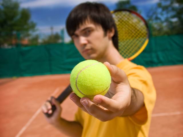 ados tenant une balle de tennis en stage sportif de tennis cet été à Yssingeaux