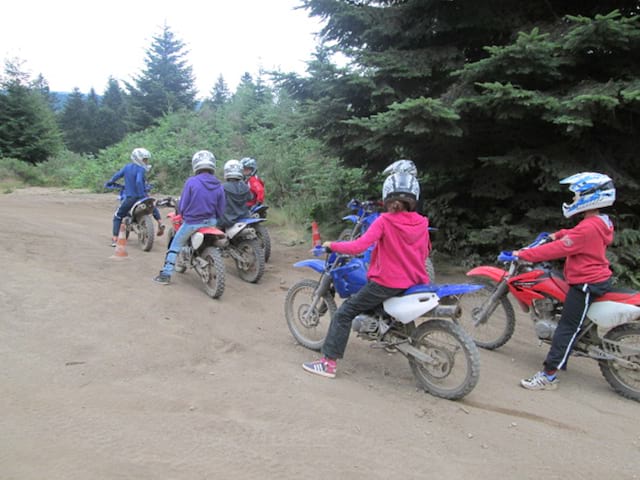 jeunes apprenant à faire de la moto grace à un stage de moto pour enfants et ados cet été