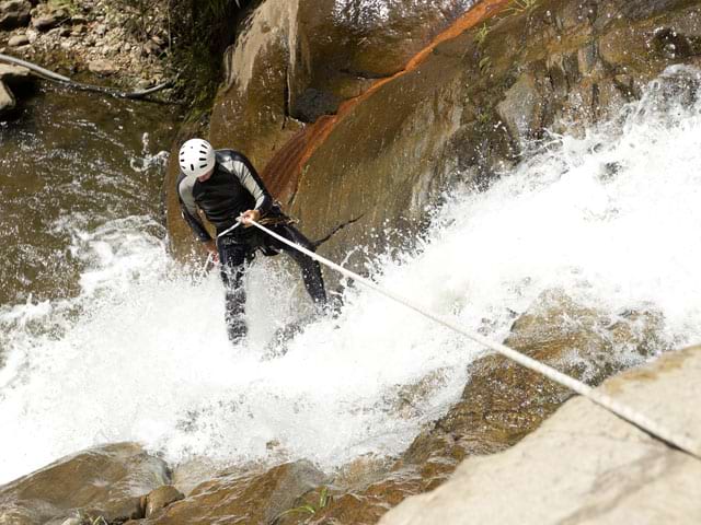 Adolescent faisant du canyoning en colonie de vacances