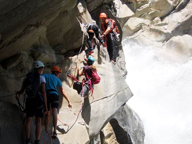 Enfants faisant de la via ferrata en colonie de vacances d'été