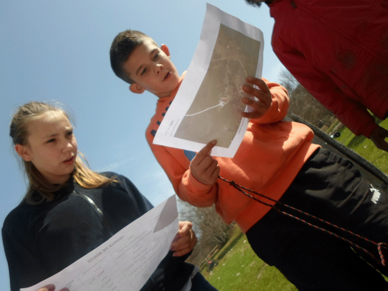 enfants apprenant à déchiffrer une carte pour s'orienter en colonie de vacances