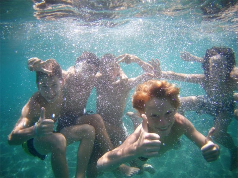 Enfants en pleine baignade durant leur séjour en colonie de vacances en Aveyron