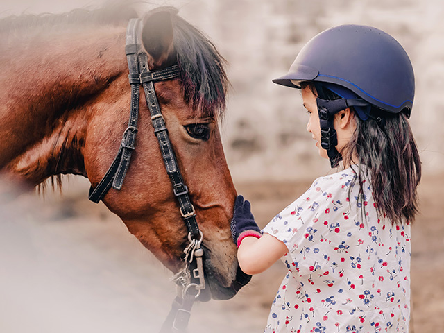 jeune fille avec cheval en colonie de vacances équitation été
