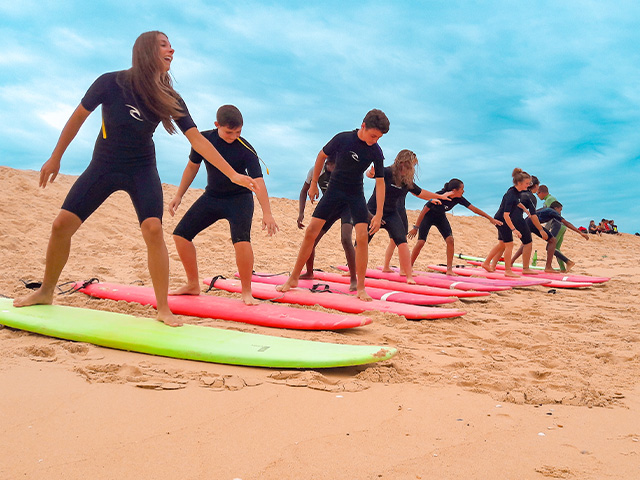 ados apprenant le surf en colonie de vacances été