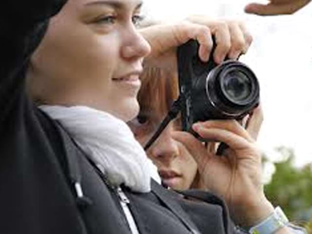 deux jeunes apprenant à faire de la photographie durant une colonie