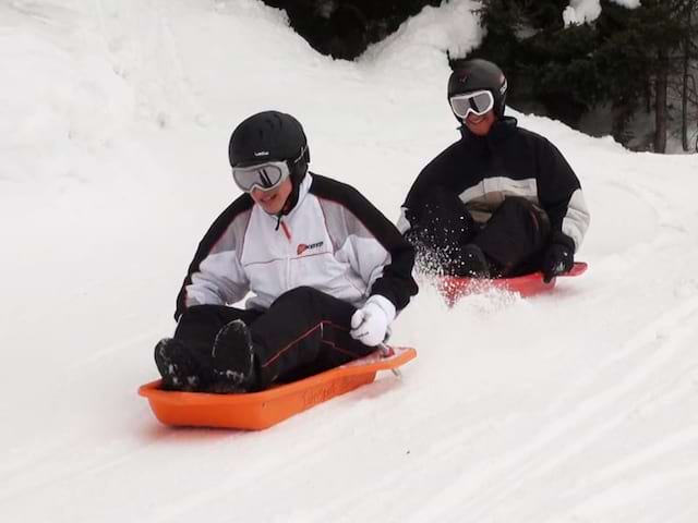 Enfants faisant de la luge en colo