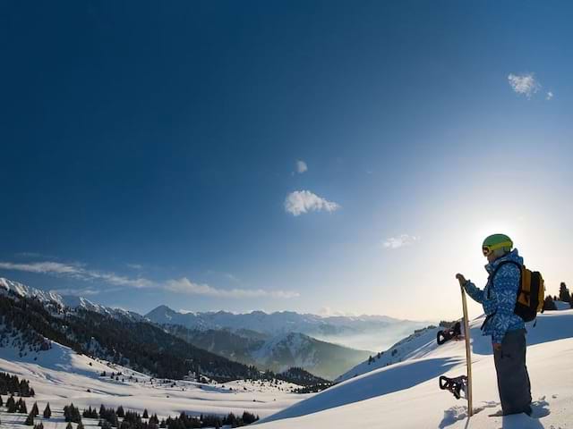 Enfant à la montagne avec son snowboard