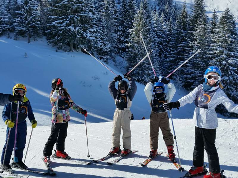 groupe de jeunes les bras leves font du ski 