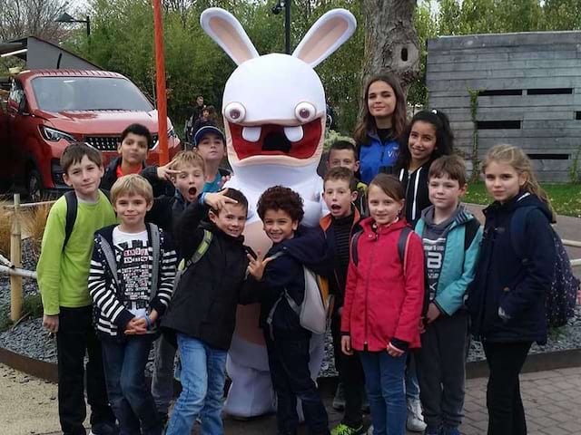 groupe d'enfants posant avec un lapin crétin en colo cet hiver