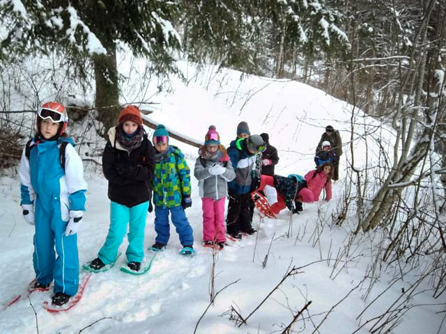 enfants avec des raquettes aux pieds sortie pendant voyage en haute savoie jeunes hiver
