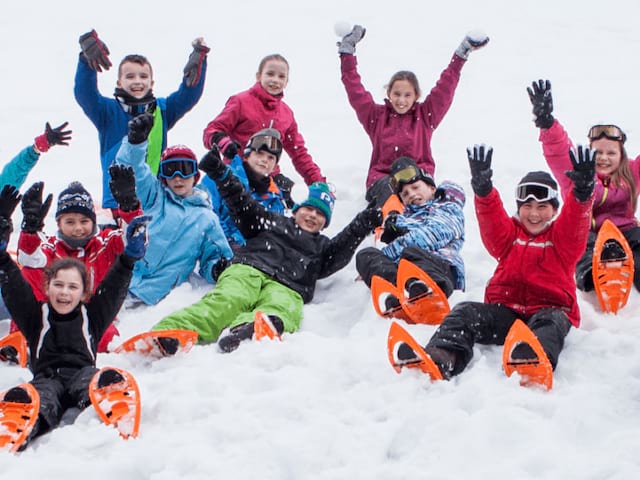 Enfants heureux et les bras levés durant leur colo de vacances Artistes en Herbe de Noel