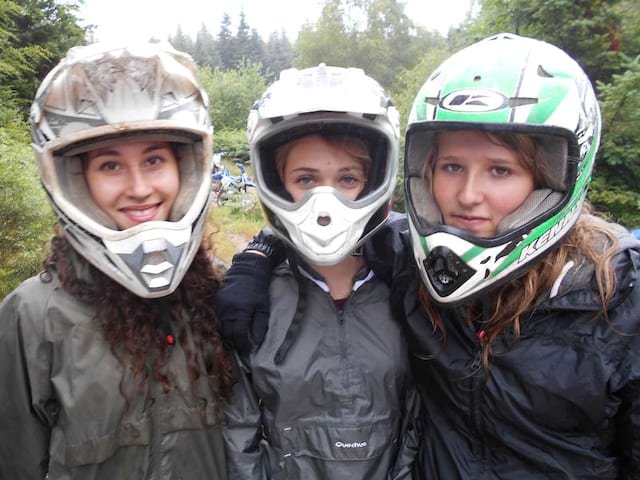 Portrait de trois ados avec un casque de moto en colo quad et moto