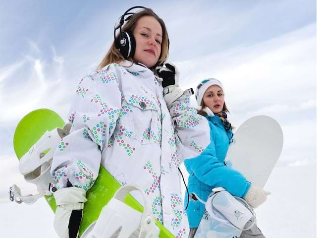 Ados pratiquant le snowboard en colo