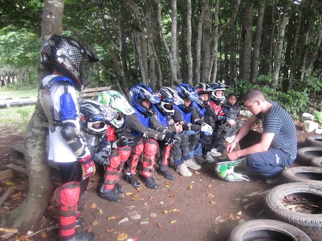 Groupe d'enfants apprenant à utiliser une moto 