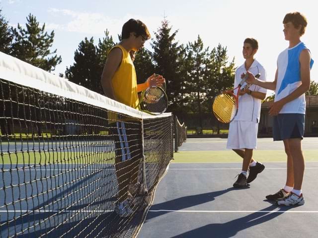 Ados jouant au tennis en stage sportif 