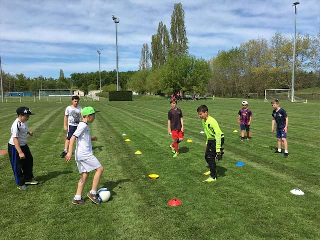 Enfants en plein entrainement de sports en colonie de vacances multisports au printemps