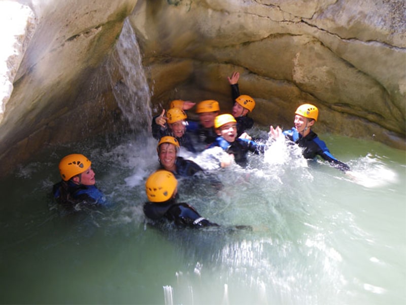 Des ados font du canyoning dans une rivière lors d'une colonie de vacances en Corse 
