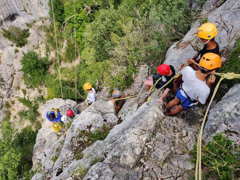 Groupe de préados sur mur naturel escalade