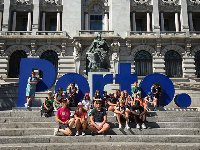 groupe de jeunes assis sur des marches a porto au portugal 