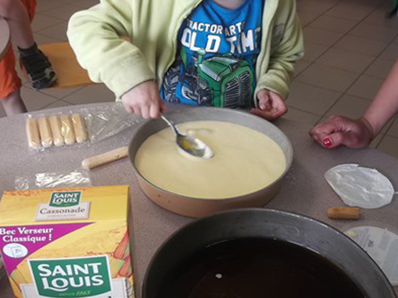 Enfant apprenant à faire la cuisine en colo