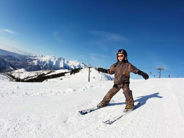 enfant dévalant les pistes en colonie de vacances cet hiver