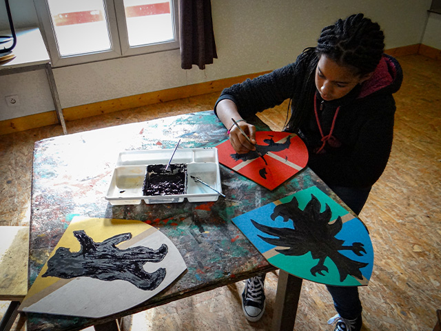 Jeune qui apprend à faire un blason