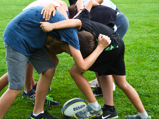 Enfants jouant au rugby en colo sportive cet été