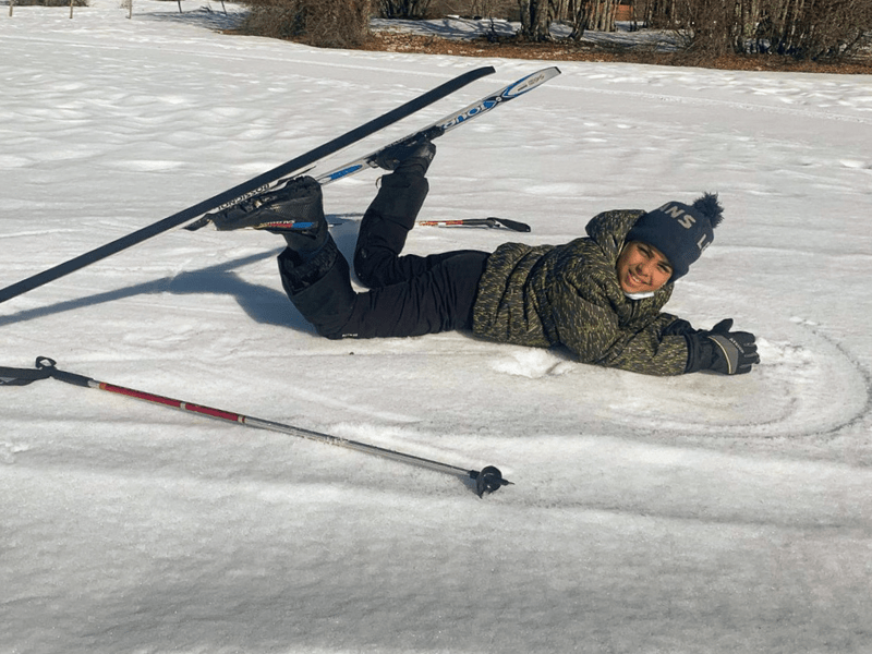 Jeune garçon en ski qui fait une pause et qui profite de sa colo de vacances cet hiver