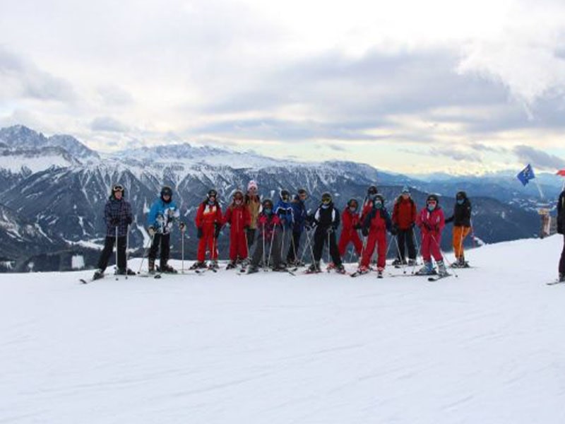 Groupe de jeunes ados en colonie de vacances Ski et Snow dans les Dolomites en hiver