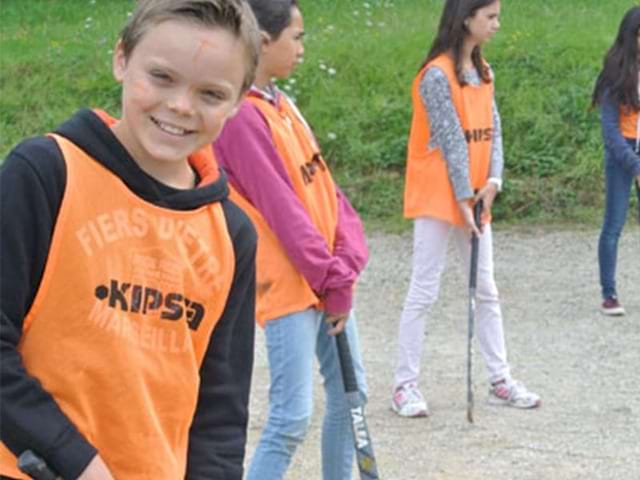 Enfants apprenant à jouer au hockey en colonie de vacances